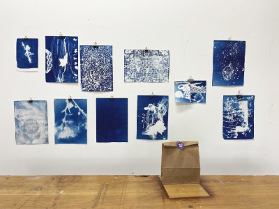 11 Blaudrucke (Cyanotypien) A5 und A4 groß hängen an der Wand