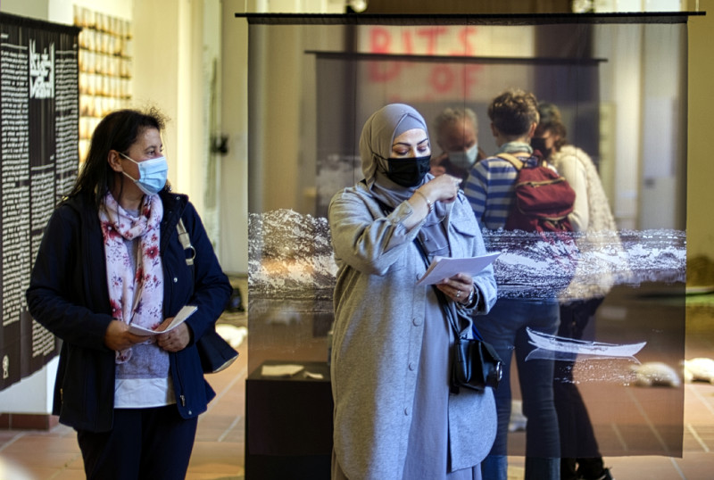 Zwei Frauen stehen vor einer Kunstinstallation, die rechte erklärt etwas
