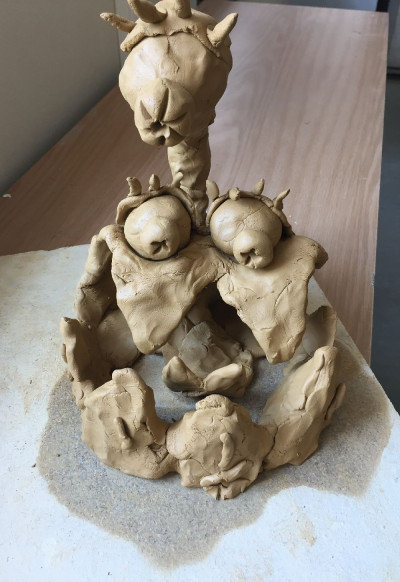 Tonfigur, sieht aus wie ein Monster, hat ein großes Auge, das an einem Hals über dem Kopf schwebt.